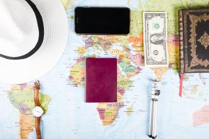 elevated-view-banknotes-smartphone-accessories-world-map